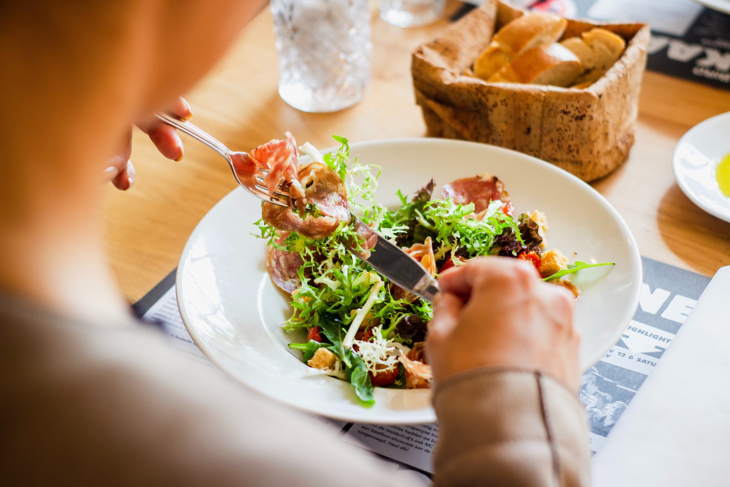 サラダを食べる女性の手元